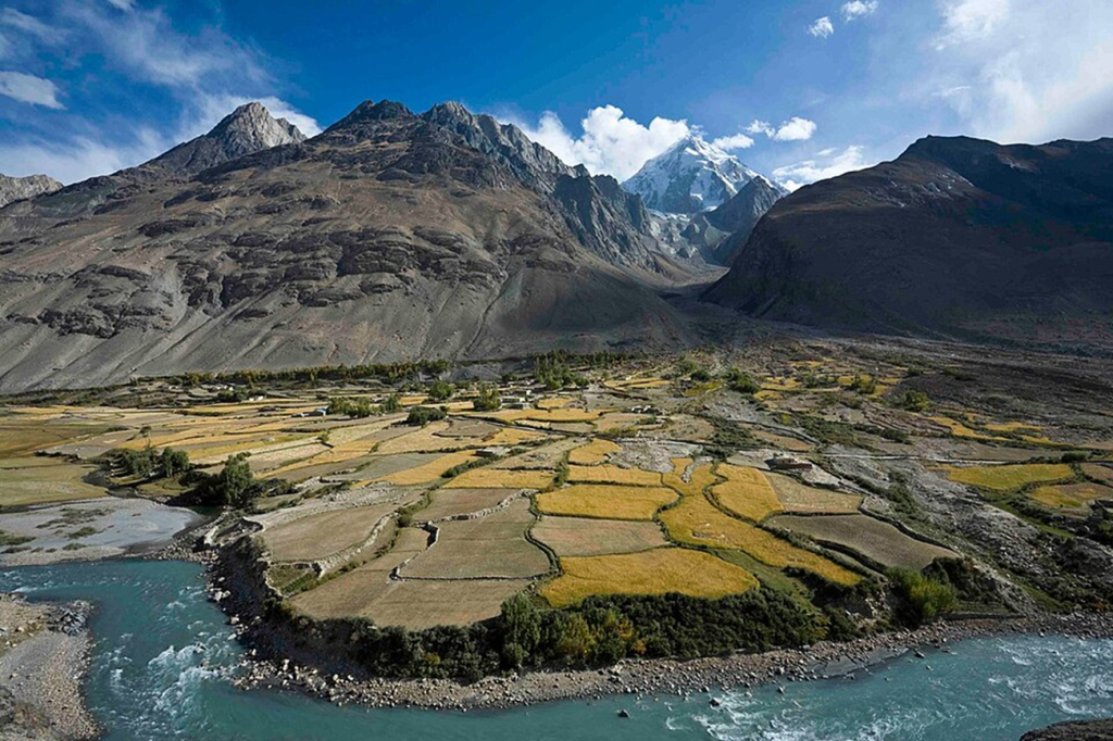 An image of the Wakhan Corridor, showing its farms and a small river bank.
